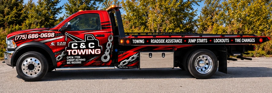 Full side view of a C&C Towing red flatbed truck